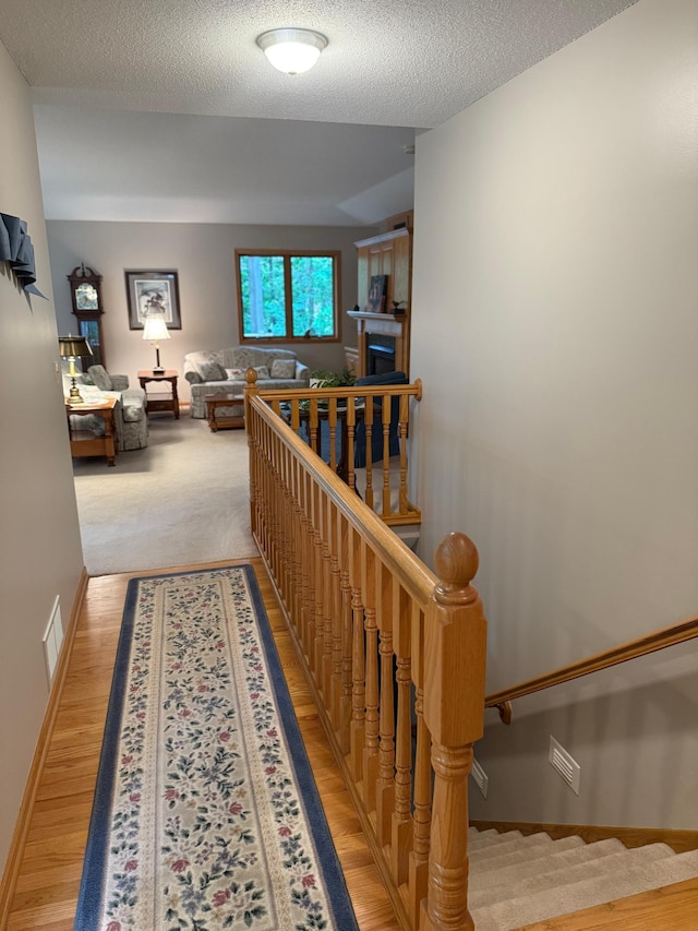 527 Woodside Ct, Shakopee, MN 55379 - hall featuring light wood-style floors and a textured ceiling