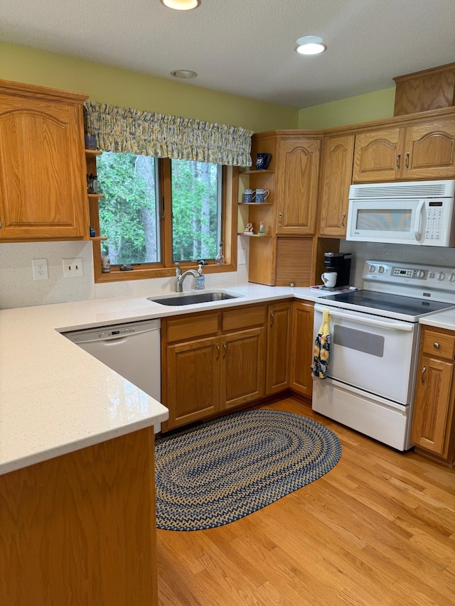 527 Woodside Ct, Shakopee, MN 55379 - kitchen with white appliances, open shelves, light wood finished floors, and brown cabinetry