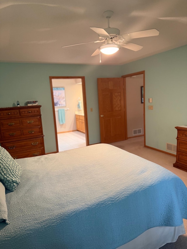 527 Woodside Ct, Shakopee, MN 55379 - bedroom with light colored carpet, connected bathroom, and a ceiling fan