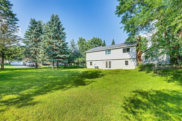 5577 Alameda St, Shoreview, MN 55126 - rear view of house with a chimney, a lawn, and french doors