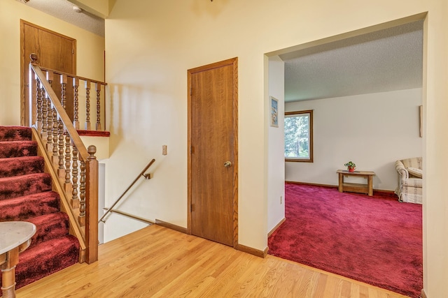 5577 Alameda St, Shoreview, MN 55126 - staircase featuring a textured ceiling and wood finished floors