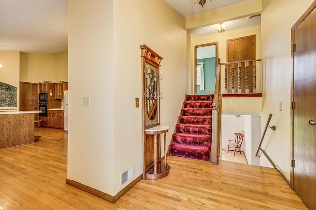 5577 Alameda St, Shoreview, MN 55126 - hallway featuring light wood-style floors and stairs