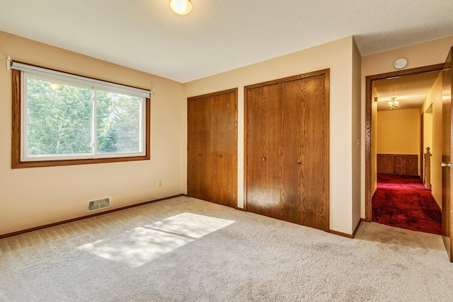 5577 Alameda St, Shoreview, MN 55126 - unfurnished bedroom with carpet flooring and multiple closets