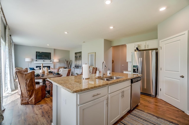 12577 Marshview Dr, Rogers, MN 55374 - kitchen with stainless steel appliances, light wood-style flooring, a center island with sink, white cabinets, and recessed lighting
