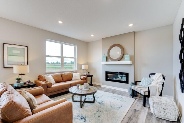 12577 Marshview Dr, Rogers, MN 55374 - living room featuring wood finished floors, recessed lighting, and a glass covered fireplace