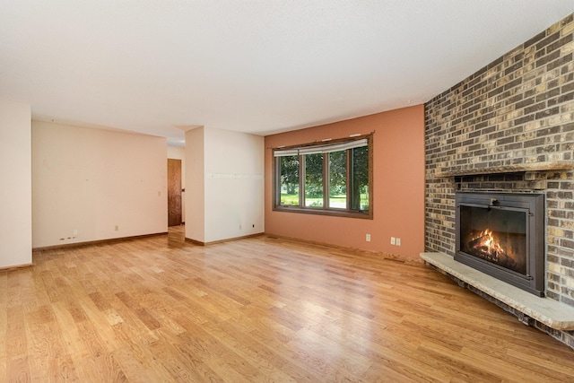 9533 Chicago Ave S, Bloomington, MN 55420 - unfurnished living room with wood finished floors and a brick fireplace