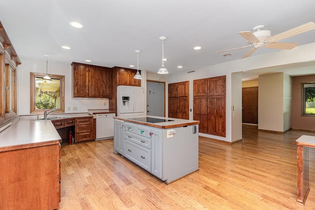 9533 Chicago Ave S, Bloomington, MN 55420 - kitchen featuring white appliances, plenty of natural light, light wood-style floors, recessed lighting, and decorative light fixtures