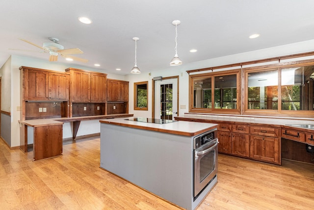 9533 Chicago Ave S, Bloomington, MN 55420 - kitchen with oven, a kitchen island, black electric cooktop, light countertops, and recessed lighting