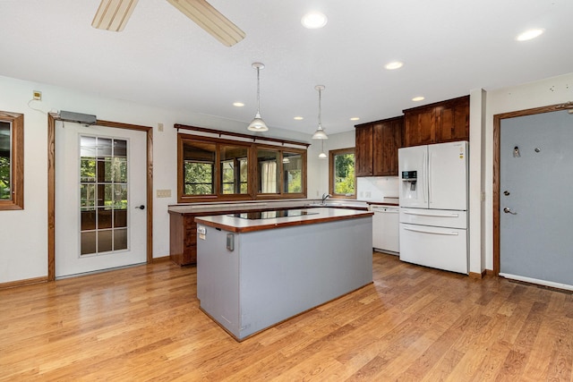9533 Chicago Ave S, Bloomington, MN 55420 - kitchen featuring white appliances, light wood-style floors, a kitchen island, recessed lighting, and pendant lighting