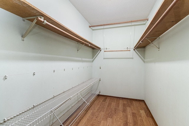 9533 Chicago Ave S, Bloomington, MN 55420 - walk in closet featuring wood finished floors