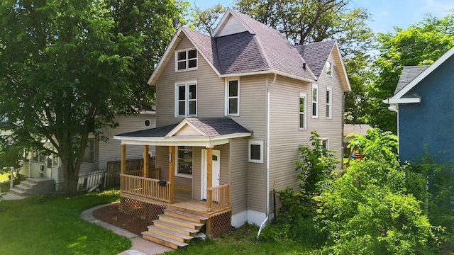 2815 Girard Ave N, Minneapolis, MN 55411 - view of front of property featuring covered porch, a shingled roof, and a front lawn