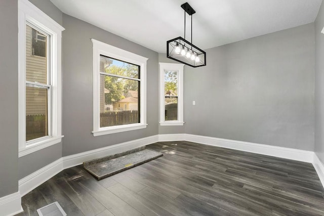 2815 Girard Ave N, Minneapolis, MN 55411 - unfurnished dining area featuring dark wood-style floors and a chandelier