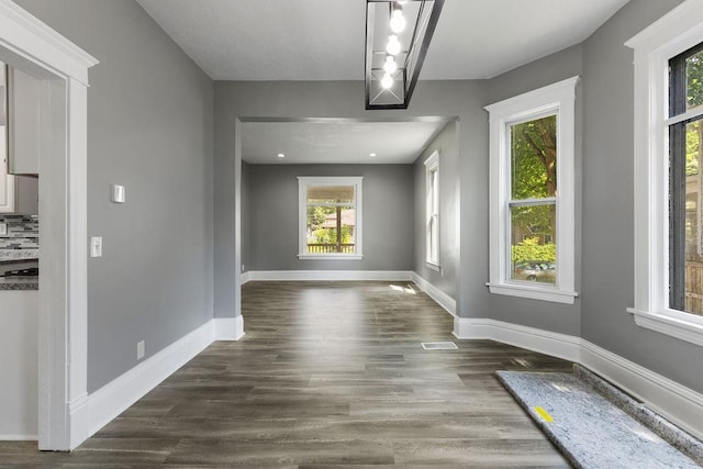 2815 Girard Ave N, Minneapolis, MN 55411 - unfurnished dining area featuring baseboards and dark wood-type flooring
