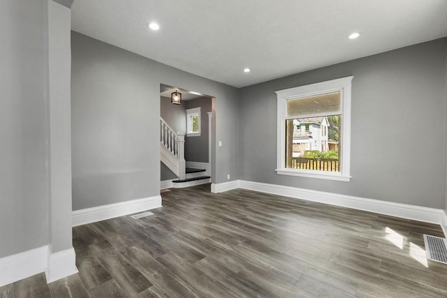 2815 Girard Ave N, Minneapolis, MN 55411 - unfurnished room featuring stairs, dark wood-style flooring, healthy amount of natural light, and recessed lighting
