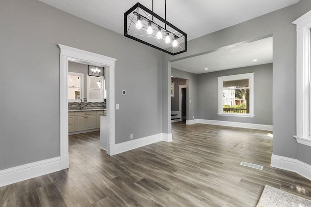 2815 Girard Ave N, Minneapolis, MN 55411 - unfurnished dining area with a chandelier and dark wood finished floors