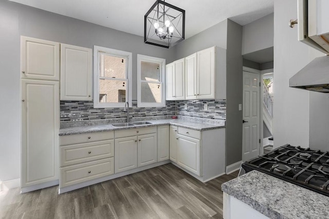 2815 Girard Ave N, Minneapolis, MN 55411 - kitchen featuring tasteful backsplash, dark wood-style floors, white cabinetry, a chandelier, and light countertops