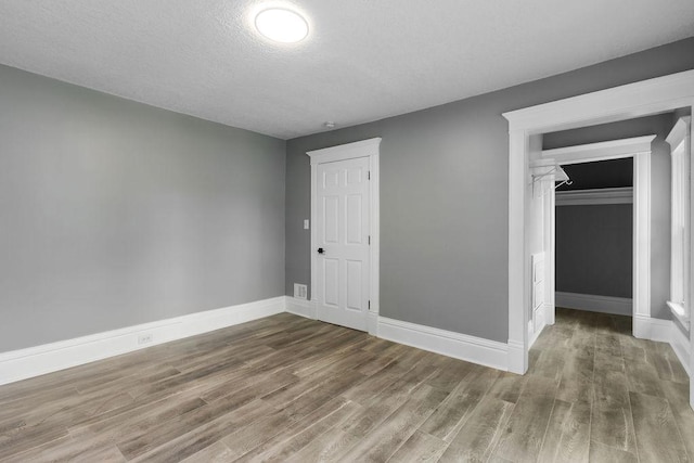 2815 Girard Ave N, Minneapolis, MN 55411 - unfurnished bedroom with wood finished floors, a textured ceiling, and a closet