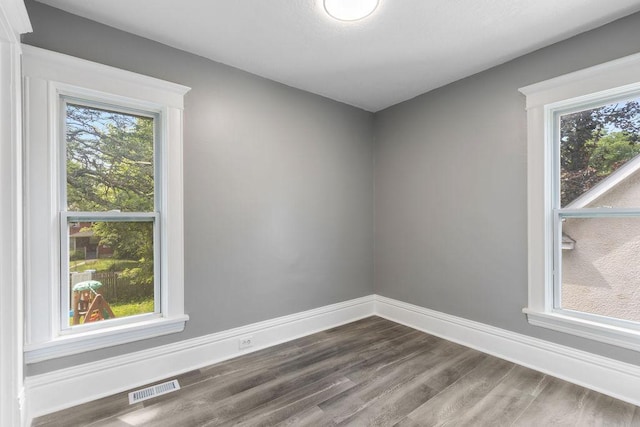 2815 Girard Ave N, Minneapolis, MN 55411 - spare room featuring dark wood-type flooring and healthy amount of natural light