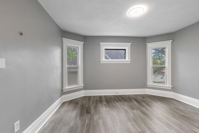 2815 Girard Ave N, Minneapolis, MN 55411 - empty room with wood finished floors and a textured ceiling