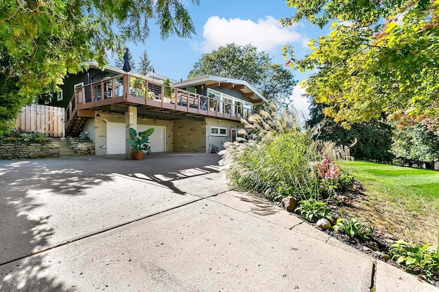 1466 Highview Ave, Eagan, MN 55121 - view of front facade with a garage, driveway, and a wooden deck