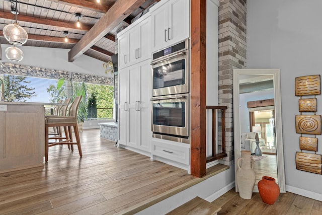 1466 Highview Ave, Eagan, MN 55121 - kitchen with double oven, a wood ceiling with exposed beams, light wood-style floors, white cabinets, and high vaulted ceiling