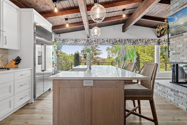 1466 Highview Ave, Eagan, MN 55121 - kitchen with built in fridge, wooden ceiling, light wood-style flooring, white cabinets, and a center island