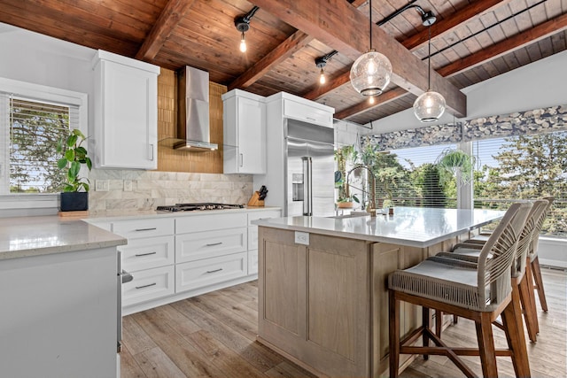 1466 Highview Ave, Eagan, MN 55121 - kitchen with wall chimney exhaust hood, wooden ceiling, appliances with stainless steel finishes, light wood-style flooring, and backsplash