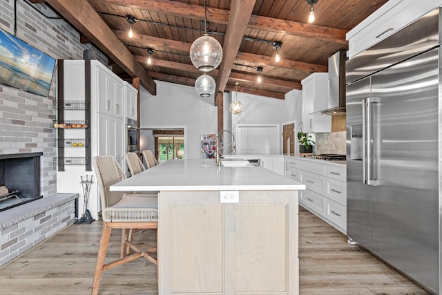 1466 Highview Ave, Eagan, MN 55121 - kitchen with built in fridge, wall chimney exhaust hood, wooden ceiling, light wood-style flooring, and a fireplace