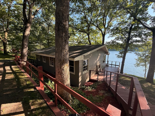 1625 Niles Ln, Balsam Lake Twp, WI 54824 - view of home's exterior featuring a shingled roof and a deck with water view