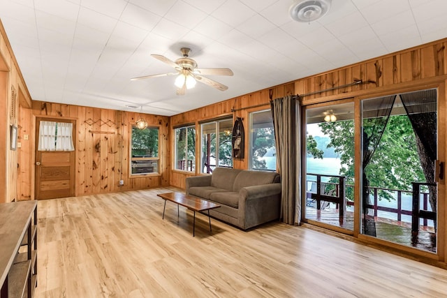 1625 Niles Ln, Balsam Lake Twp, WI 54824 - living area with wood walls, a ceiling fan, and light wood finished floors
