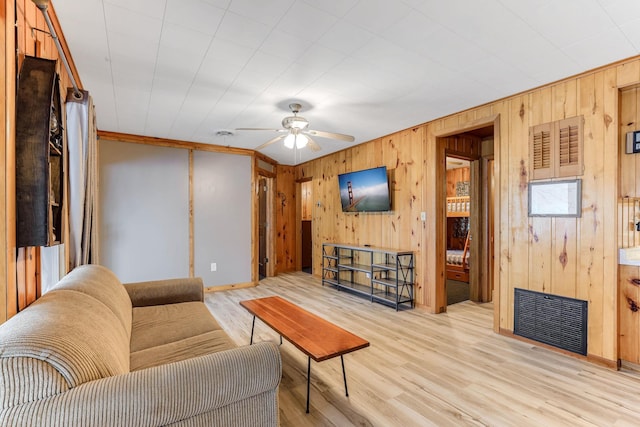 1625 Niles Ln, Balsam Lake Twp, WI 54824 - living area with wood walls, a ceiling fan, and light wood finished floors