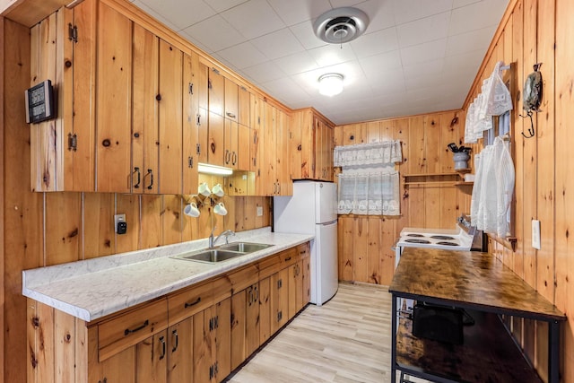 1625 Niles Ln, Balsam Lake Twp, WI 54824 - kitchen featuring white appliances, wood walls, light wood-style floors, and light countertops