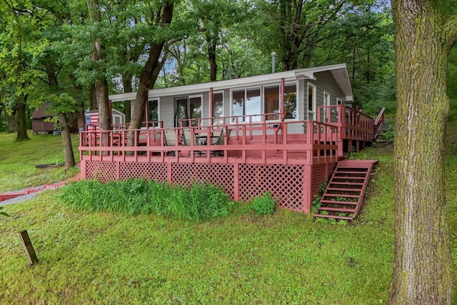 1625 Niles Ln, Balsam Lake Twp, WI 54824 - view of front facade featuring a deck, stairway, and a front yard