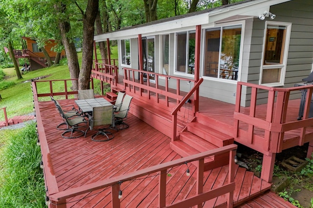 1625 Niles Ln, Balsam Lake Twp, WI 54824 - wooden terrace featuring outdoor dining area and a sunroom