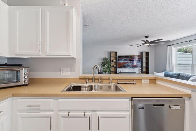 6845 Christian Curv, Woodbury, MN 55125 - kitchen featuring stainless steel dishwasher, a textured ceiling, open floor plan, light countertops, and white cabinets