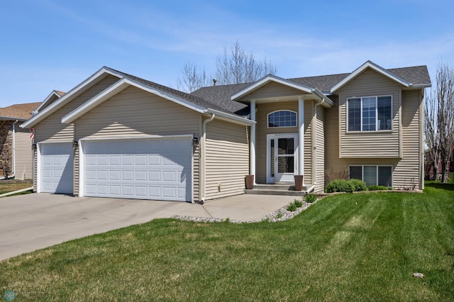 1623 10th St W, West Fargo, ND 58078 - view of front of house featuring a garage, driveway, a front yard, and roof with shingles