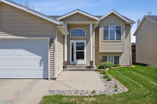 1623 10th St W, West Fargo, ND 58078 - view of front of property featuring a front lawn, an attached garage, and driveway