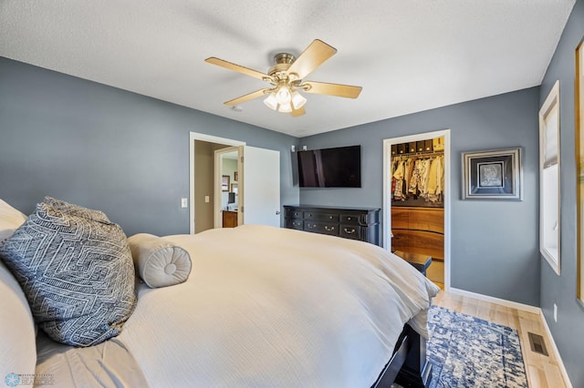 1623 10th St W, West Fargo, ND 58078 - bedroom with wood finished floors, a spacious closet, ceiling fan, and a closet