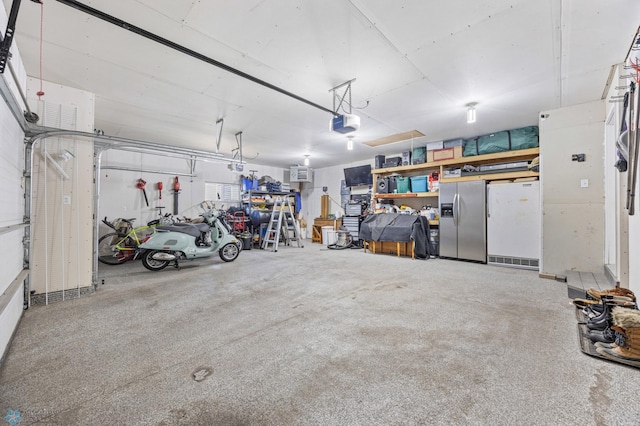 1623 10th St W, West Fargo, ND 58078 - garage with stainless steel fridge with ice dispenser, freestanding refrigerator, and a garage door opener