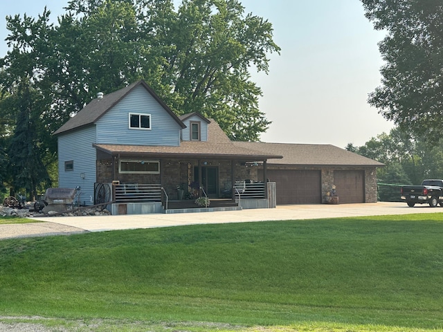 28040 Csah 25, Swede Grove Twp, MN 56243 - view of front of home with a porch, driveway, a garage, and a front yard