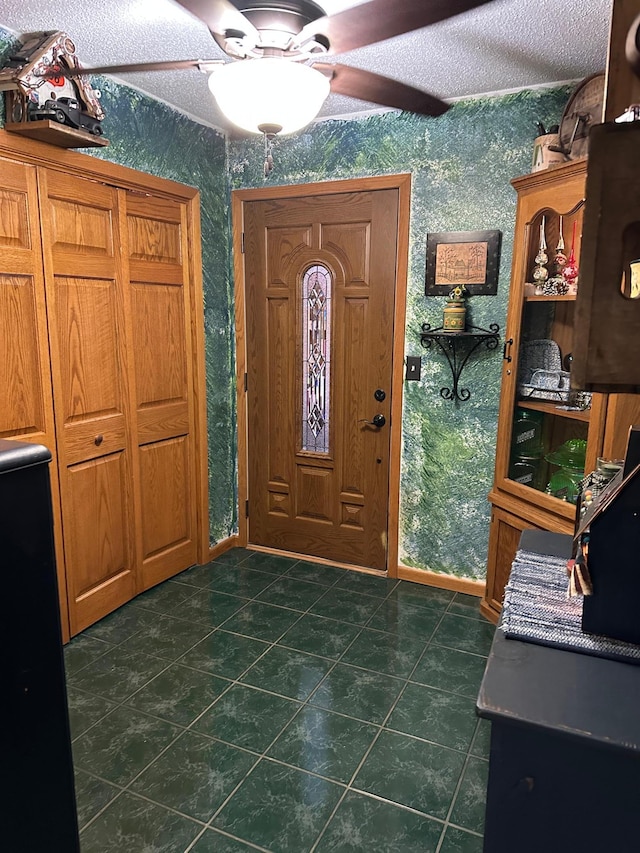 28040 Csah 25, Swede Grove Twp, MN 56243 - foyer entrance with wallpapered walls, dark tile patterned floors, and a ceiling fan