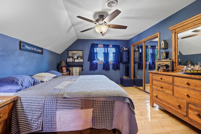 28040 Csah 25, Swede Grove Twp, MN 56243 - bedroom featuring a closet, light wood finished floors, a textured ceiling, lofted ceiling, and ceiling fan