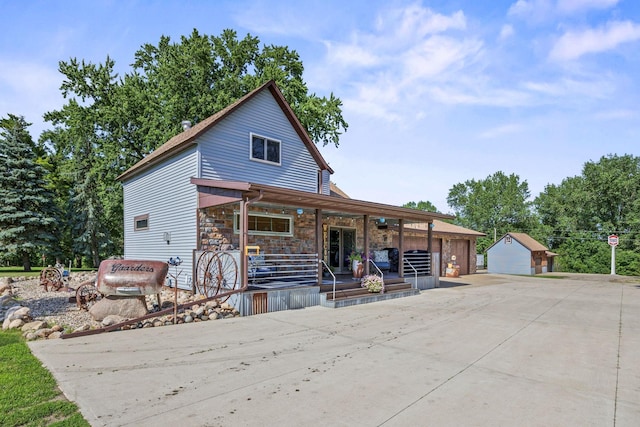 28040 Csah 25, Swede Grove Twp, MN 56243 - view of front of home with a porch, an outdoor structure, and stone siding