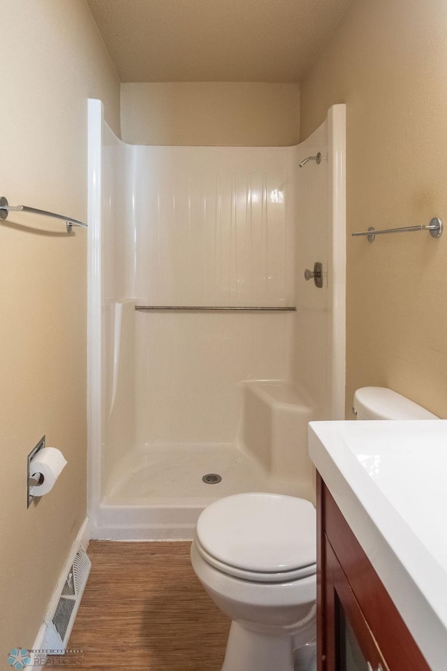 2321 17th Ave S, Fargo, ND 58103 - full bath featuring vanity, a walk in shower, and wood finished floors