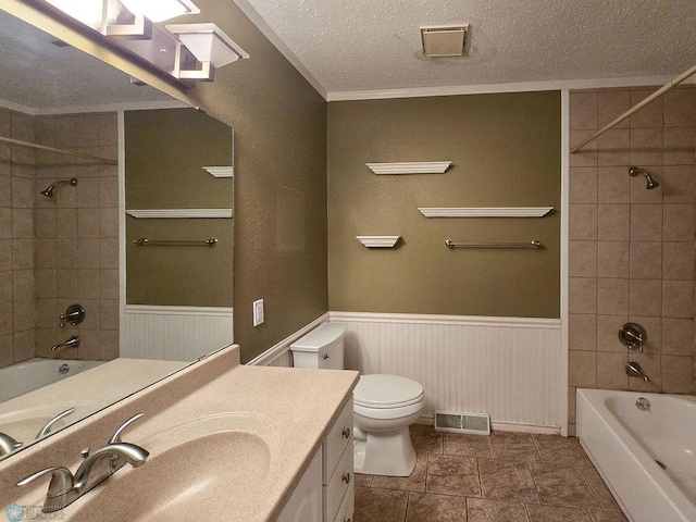 2321 17th Ave S, Fargo, ND 58103 - full bathroom with vanity, a textured ceiling, washtub / shower combination, and wainscoting