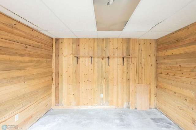 2321 17th Ave S, Fargo, ND 58103 - spare room with wood walls, unfinished concrete floors, and a paneled ceiling
