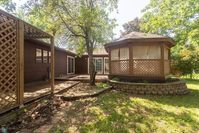 2321 17th Ave S, Fargo, ND 58103 - view of grassy yard with a deck and a sunroom