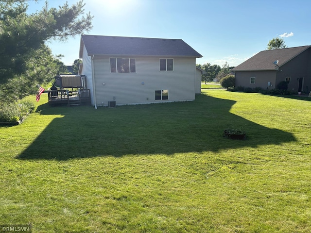 500 Albion Pl, Maple Lake, MN 55358 - rear view of house featuring a wooden deck and a lawn