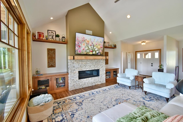 26888 734th Ave, Dassel Twp, MN 55325 - living area with high vaulted ceiling, wood finished floors, a fireplace, and recessed lighting