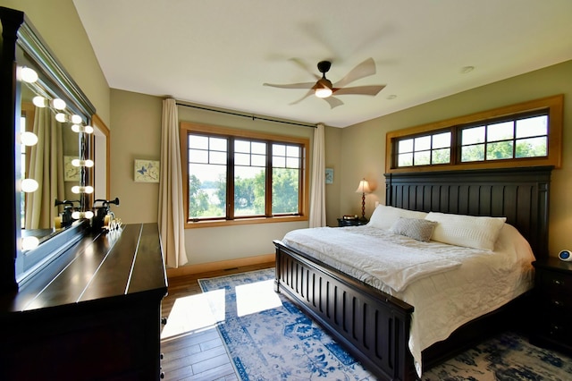 26888 734th Ave, Dassel Twp, MN 55325 - bedroom with multiple windows, wood finished floors, and ceiling fan